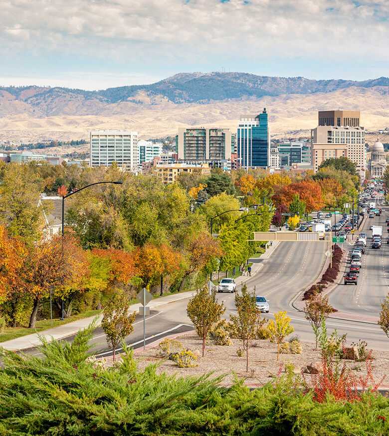 Autumn colors in a park with Boise city skyline in the background, an optimal area for personal injury lawyers.