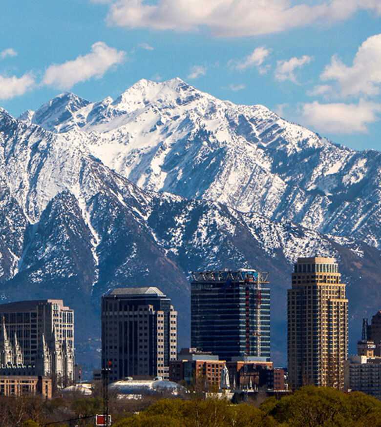 Salt Lake City skyline with snowy mountains, representing steadfast support from personal injury lawyers in the area.