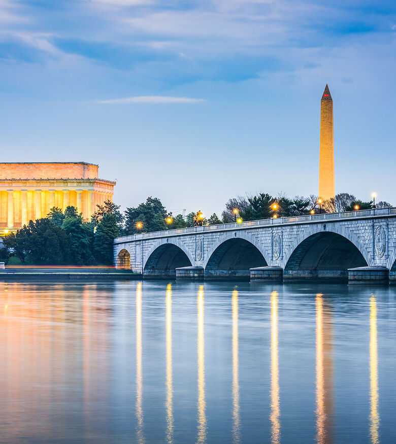 Iconic Washington DC monuments reflected in the water at sunrise, a prestigious area for personal injury lawyers.