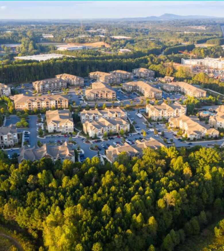 Expansive aerial view of Alpharetta with lush greenery and office complexes, prime for personal injury lawyers.