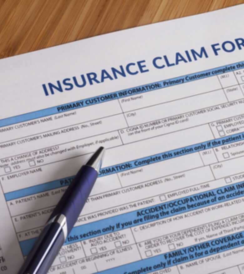 Detailed view of an insurance claim form with pen