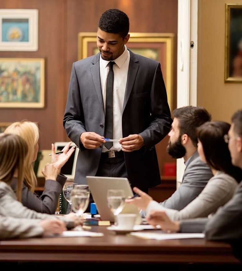 Attorney presenting a case to a group of clients in an elegant law firm conference room