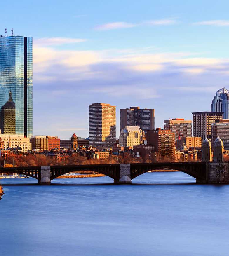Boston skyline with reflective waters, prime for personal injury lawyers.