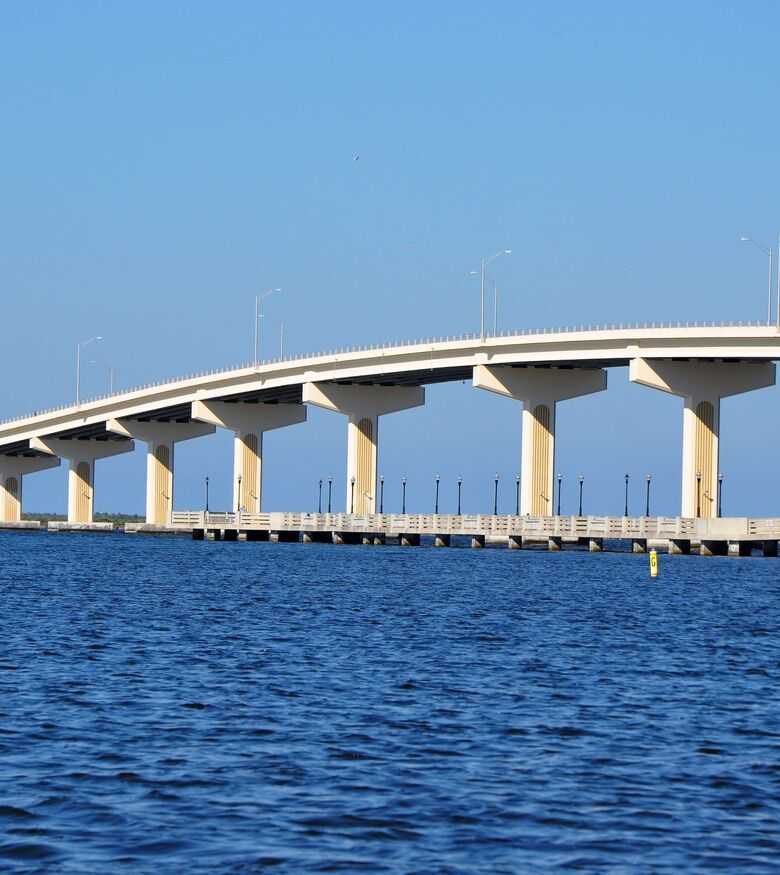 Long arched bridge over blue waters in Titusville, an iconic landmark for advertising Personal Injury Lawyers.