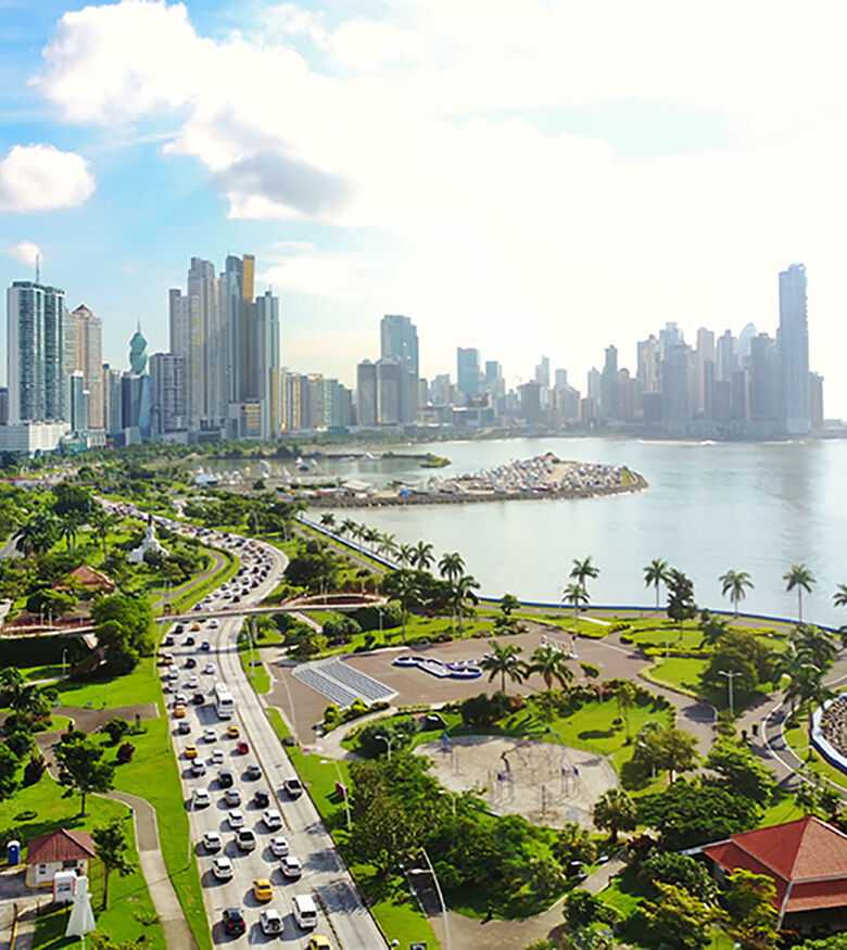 Panama City skyline viewed from a lush park, symbolizing the support of personal injury lawyers in the city.